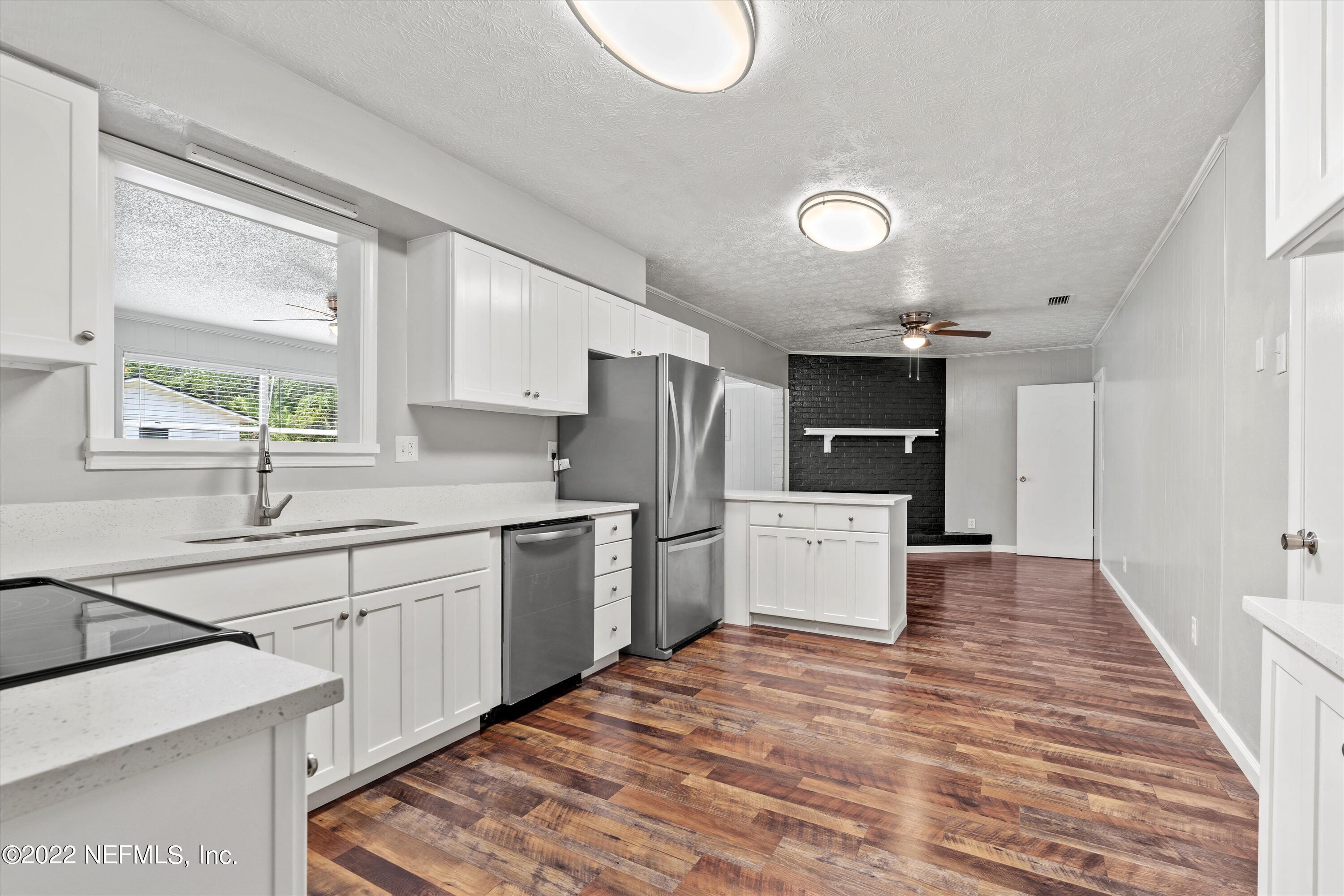 5092 Harvey Grant Road Fleming Island, FL 32003 - Photo 11 of 38 a kitchen with a stove a sink and a refrigerator