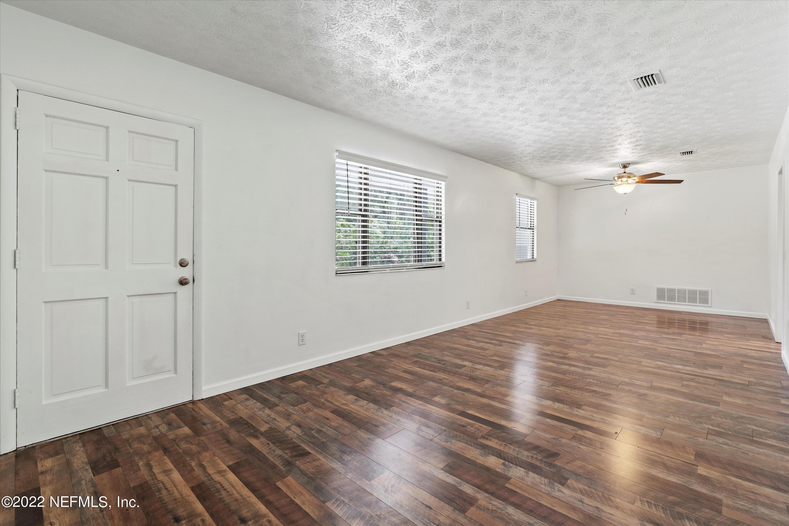 5092 Harvey Grant Road Fleming Island, FL 32003 - Photo 13 of 38 a view of empty room with wooden floor and fan