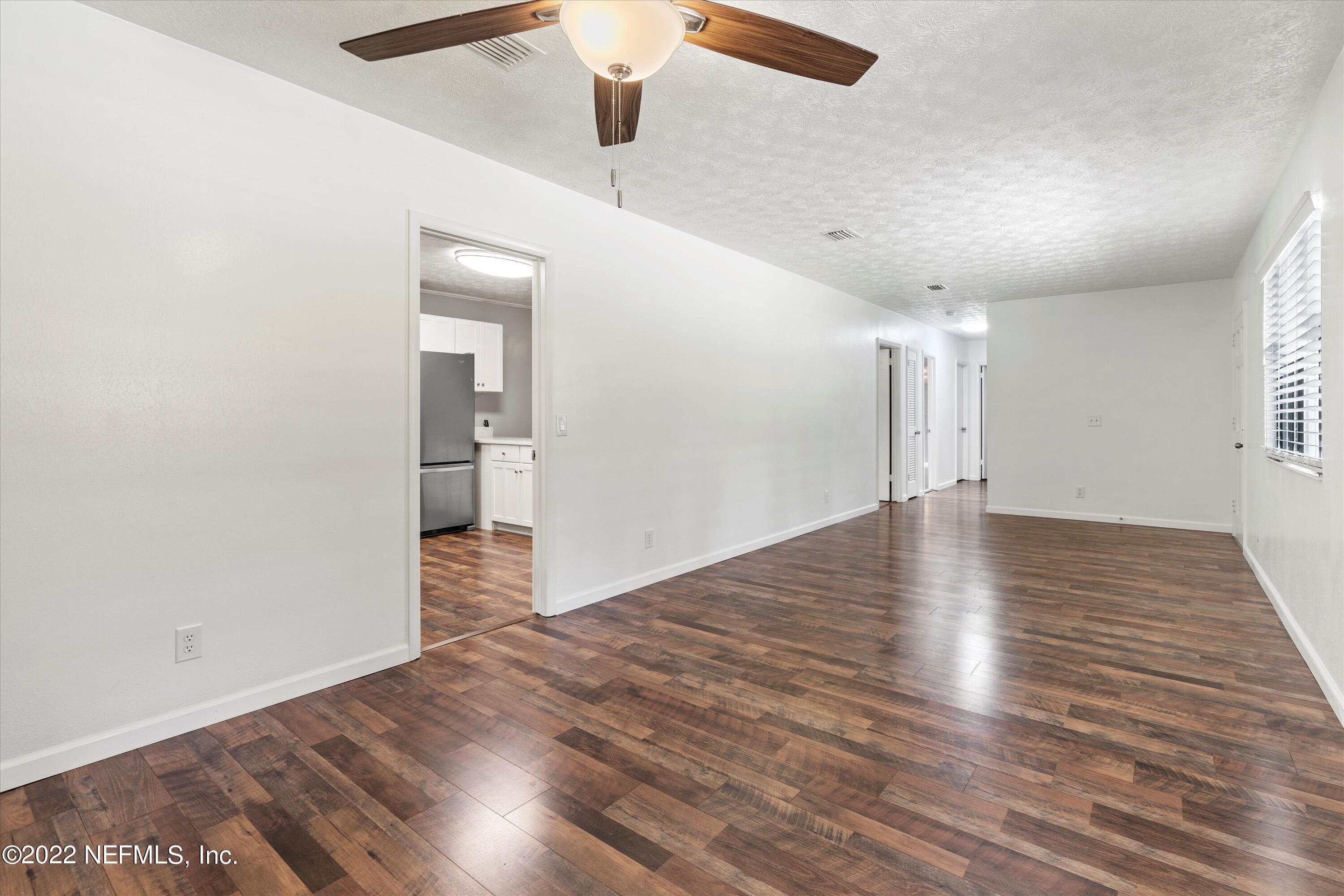 5092 Harvey Grant Road Fleming Island, FL 32003 - Photo 14 of 38 an empty room with wooden floor and entryway