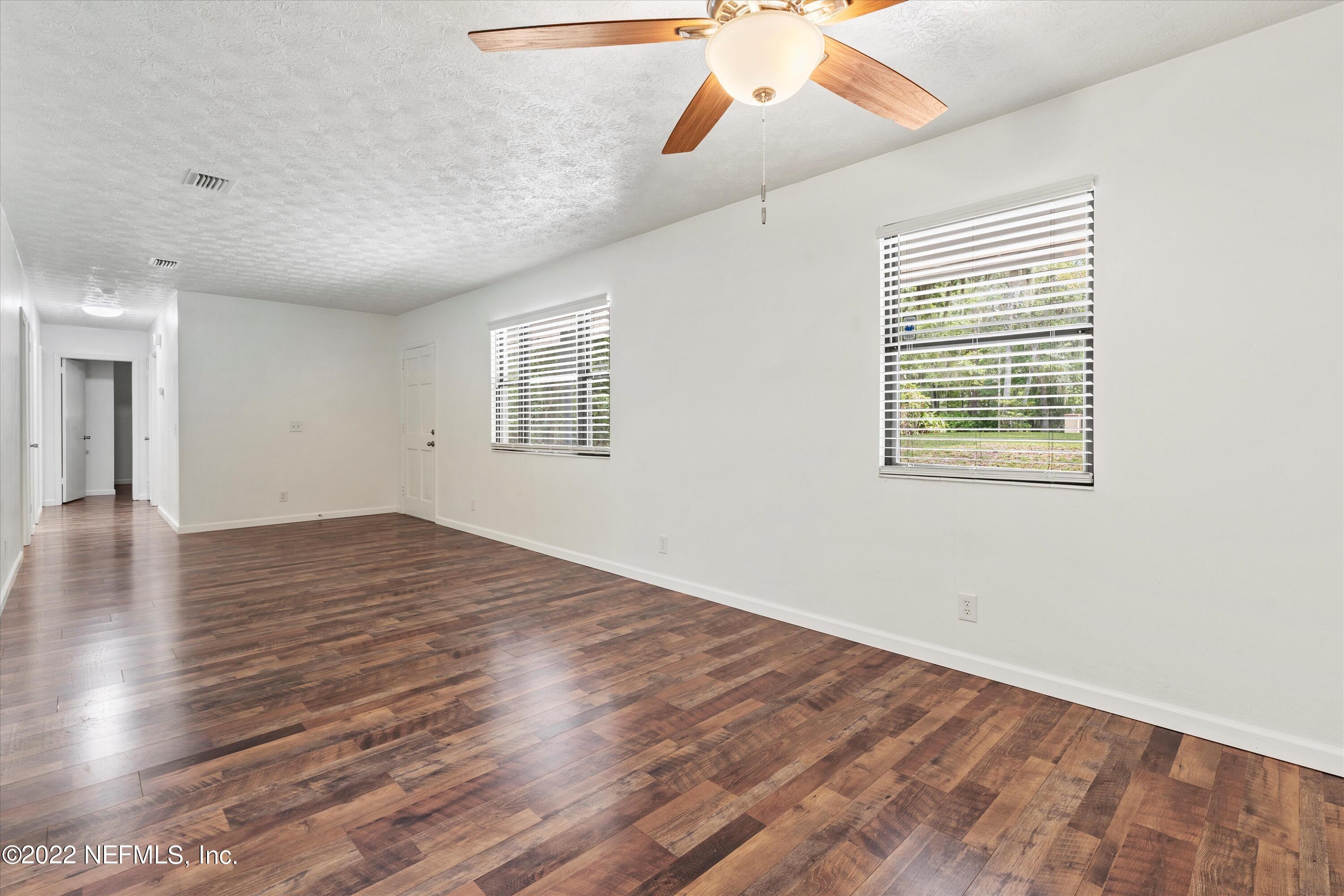 5092 Harvey Grant Road Fleming Island, FL 32003 - Photo 15 of 38 wooden floor in an empty room with a window