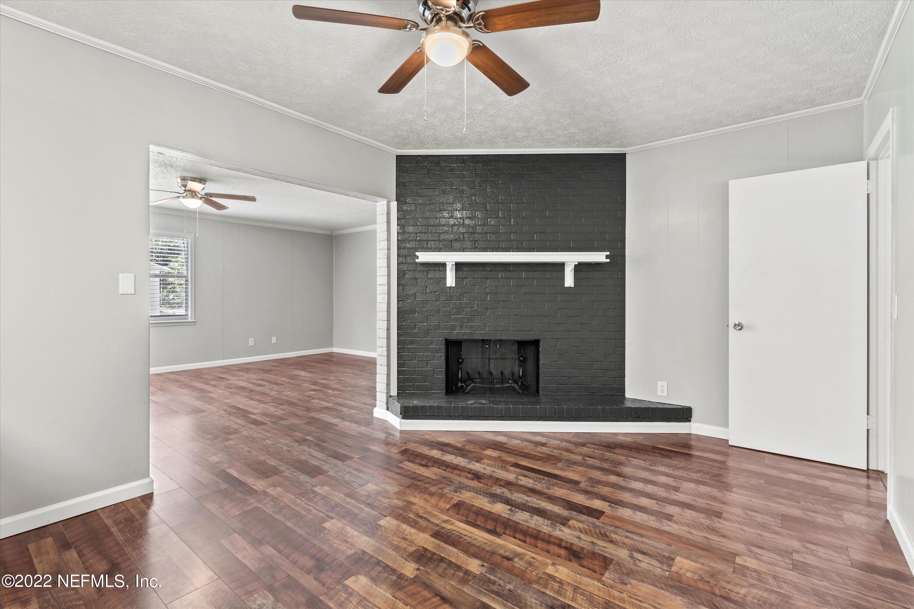 5092 Harvey Grant Road Fleming Island, FL 32003 - Photo 16 of 38 a view of a livingroom with a fireplace and wooden floor