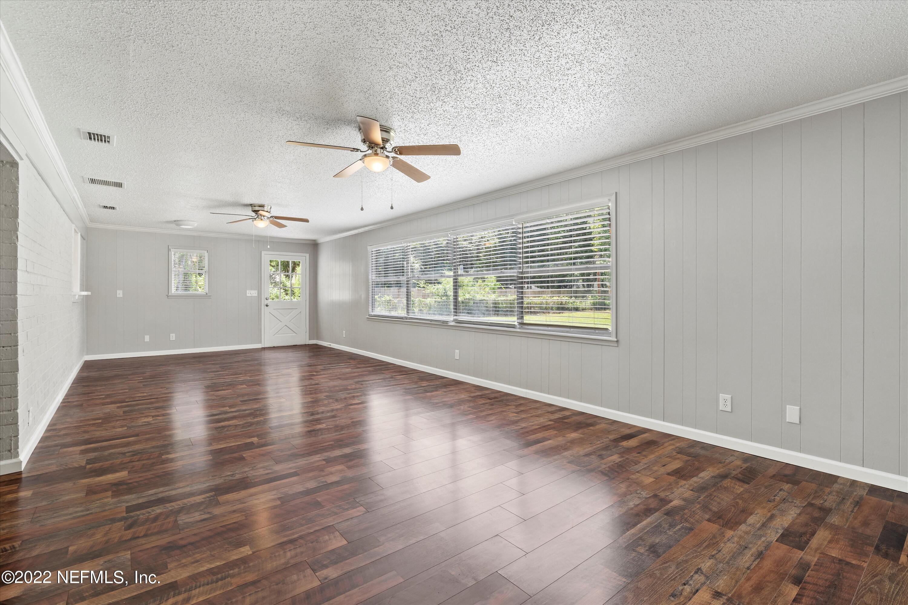 5092 Harvey Grant Road Fleming Island, FL 32003 - Photo 17 of 38 a view of an empty room with wooden floor and a window