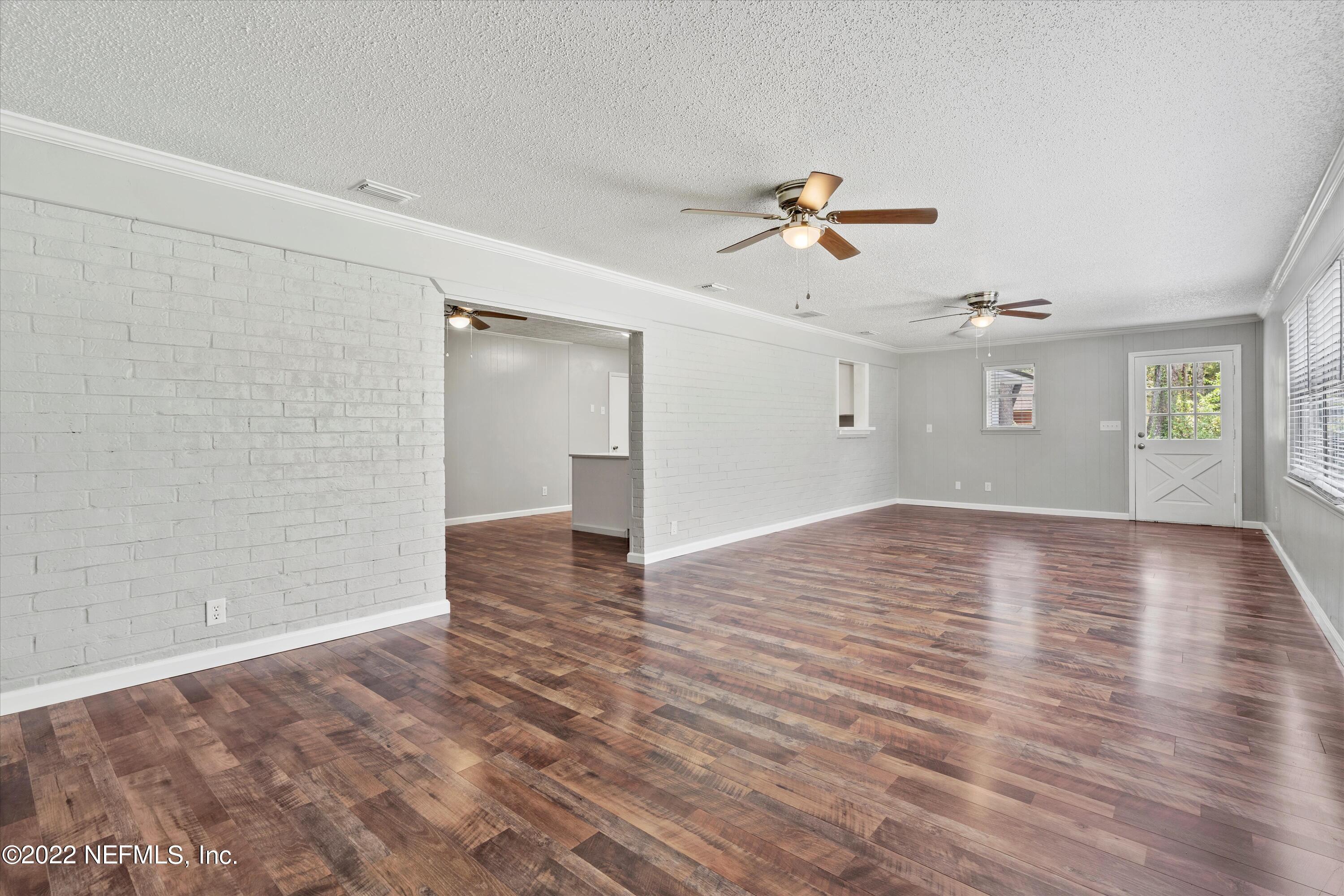 5092 Harvey Grant Road Fleming Island, FL 32003 - Photo 18 of 38 a view of empty room with wooden floor and ceiling fan