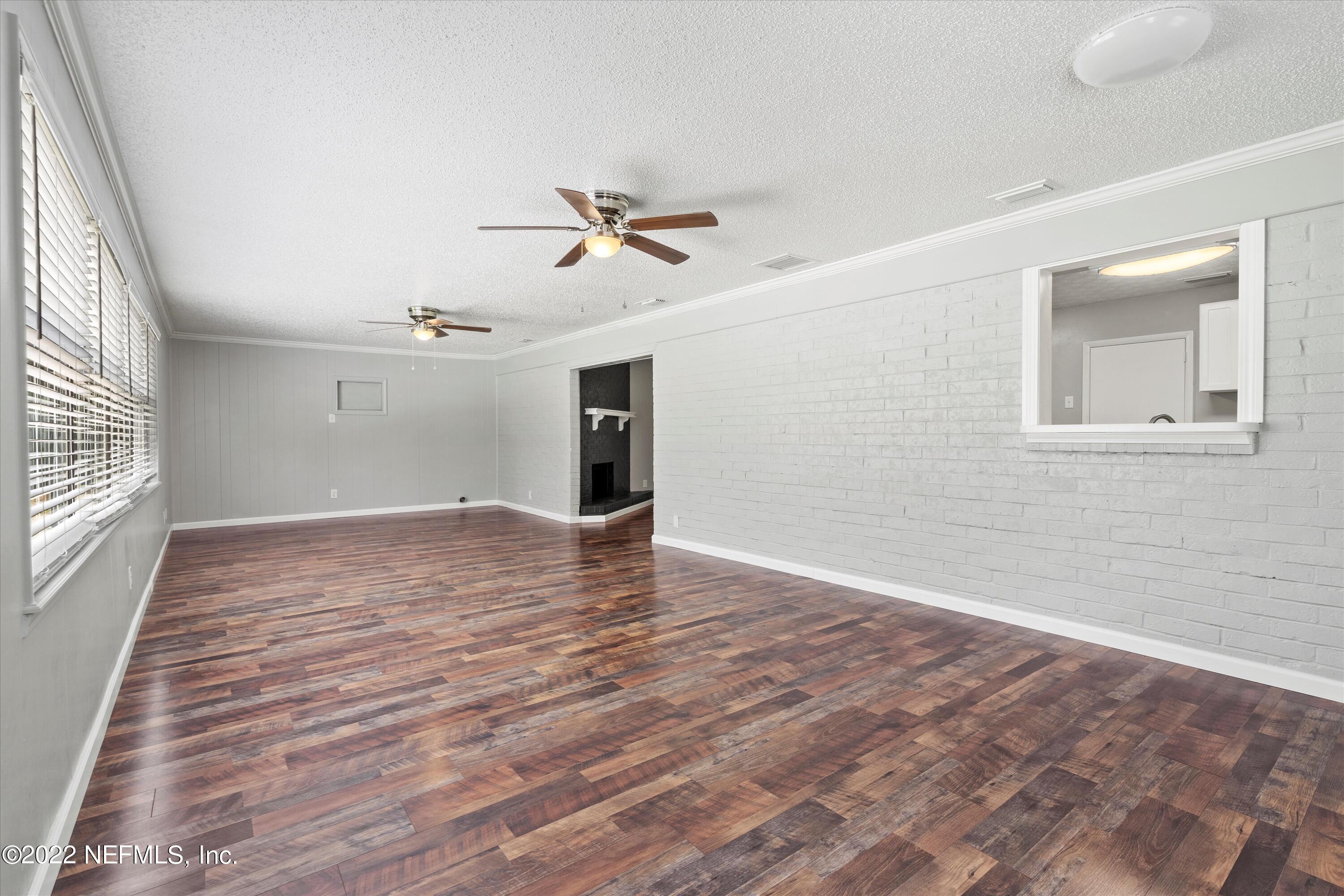 5092 Harvey Grant Road Fleming Island, FL 32003 - Photo 19 of 38 wooden floor in an empty room with a window