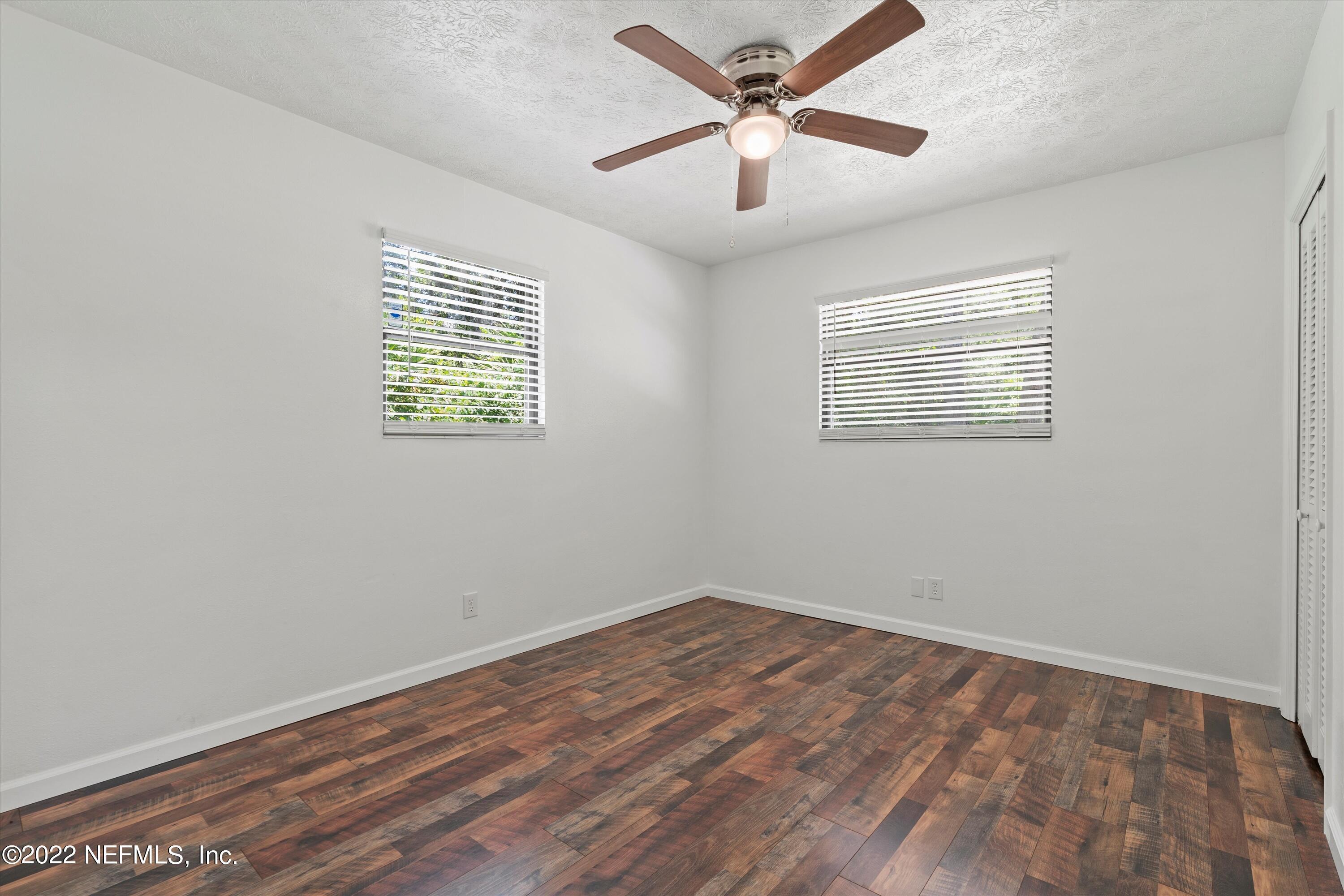 5092 Harvey Grant Road Fleming Island, FL 32003 - Photo 24 of 38 wooden floor in an empty room with a window