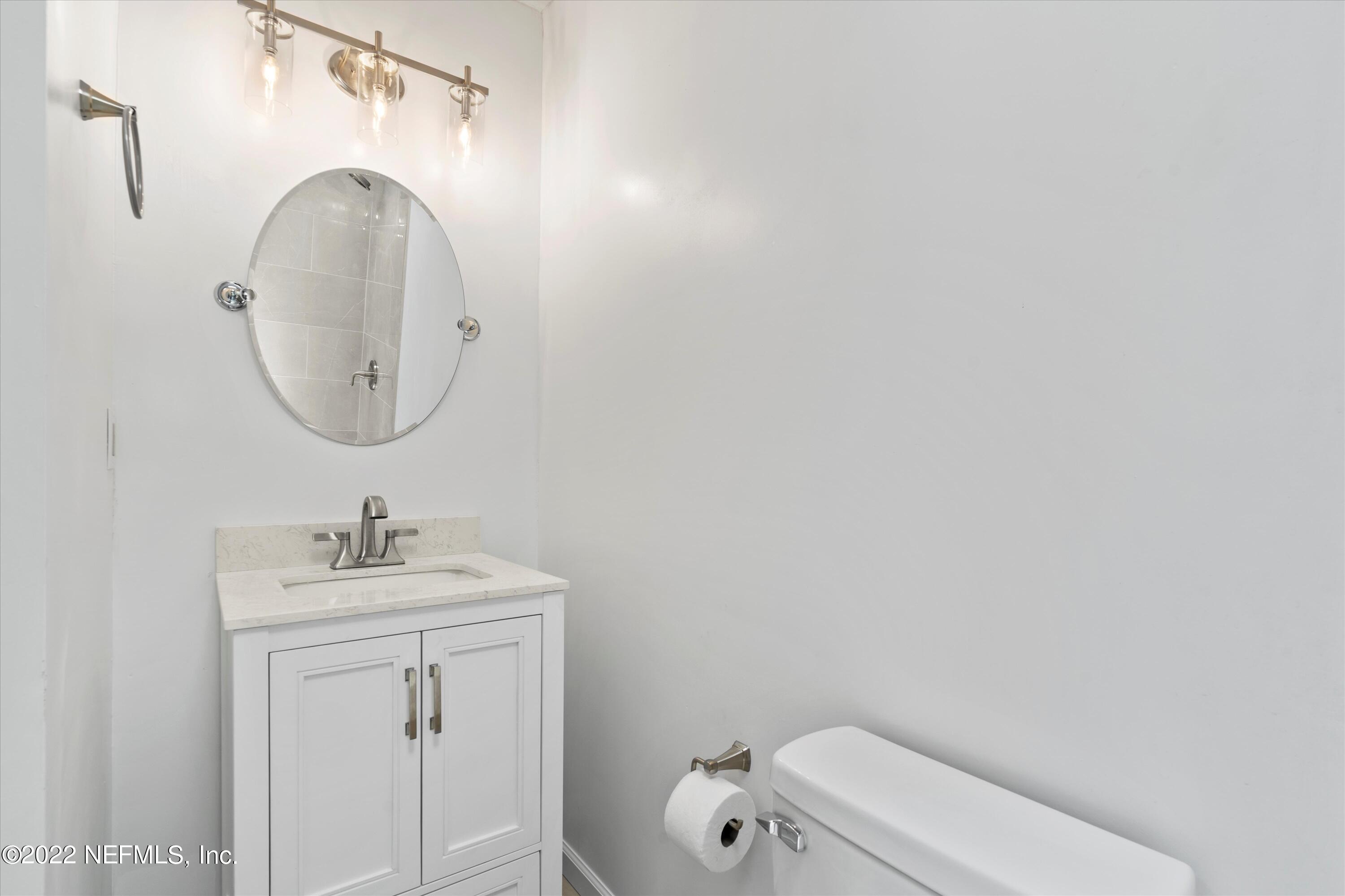 5092 Harvey Grant Road Fleming Island, FL 32003 - Photo 26 of 38 a bathroom with a sink and a mirror