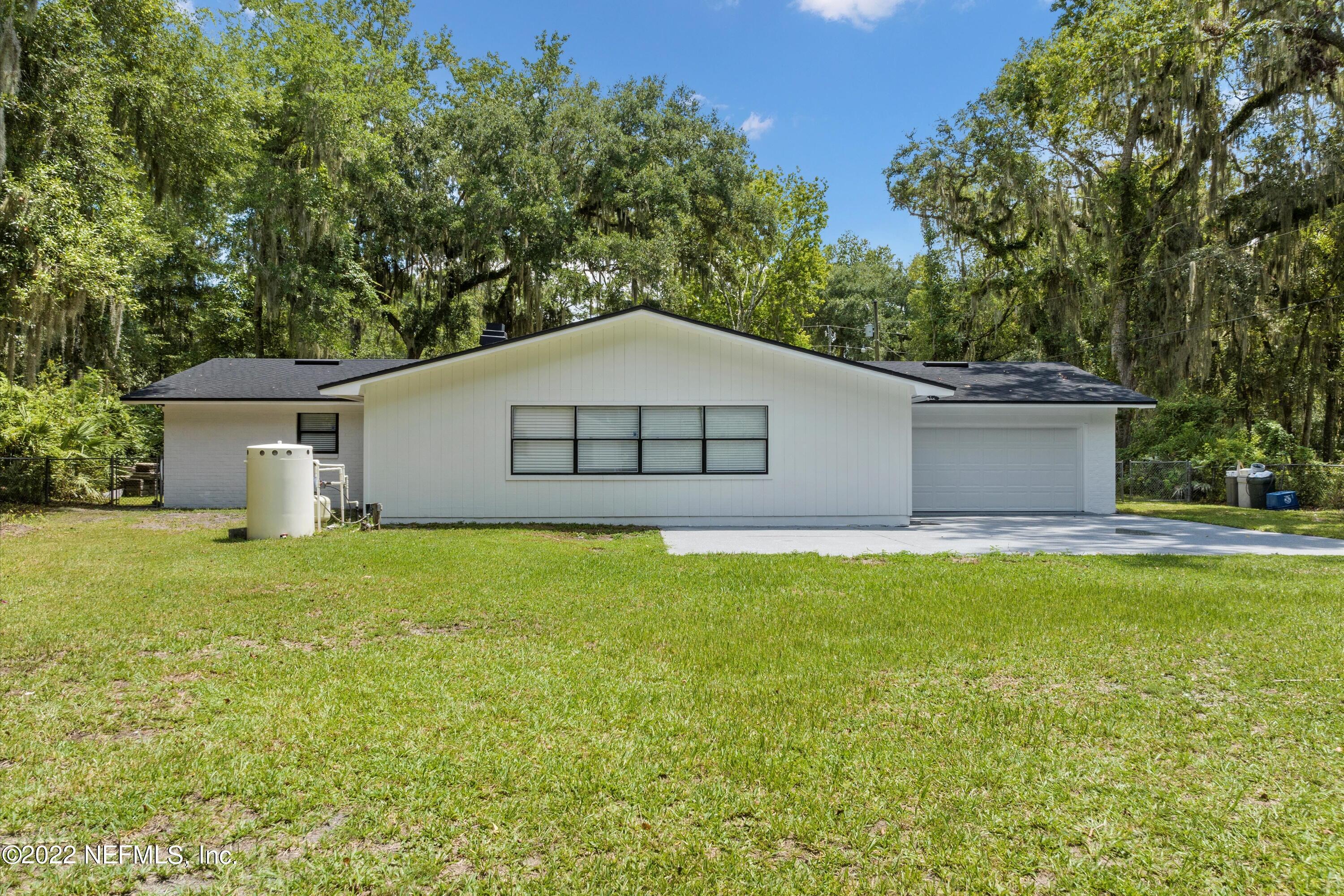 5092 Harvey Grant Road Fleming Island, FL 32003 - Photo 29 of 38 a house that has a big yard with large trees