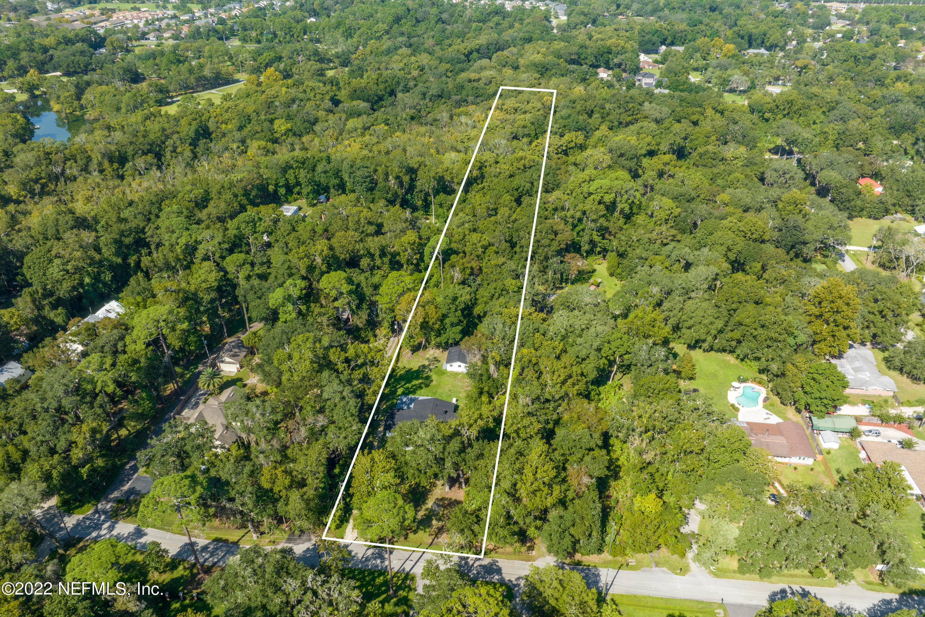 5092 Harvey Grant Road Fleming Island, FL 32003 - Photo 3 of 38 a view of a yard with a tree