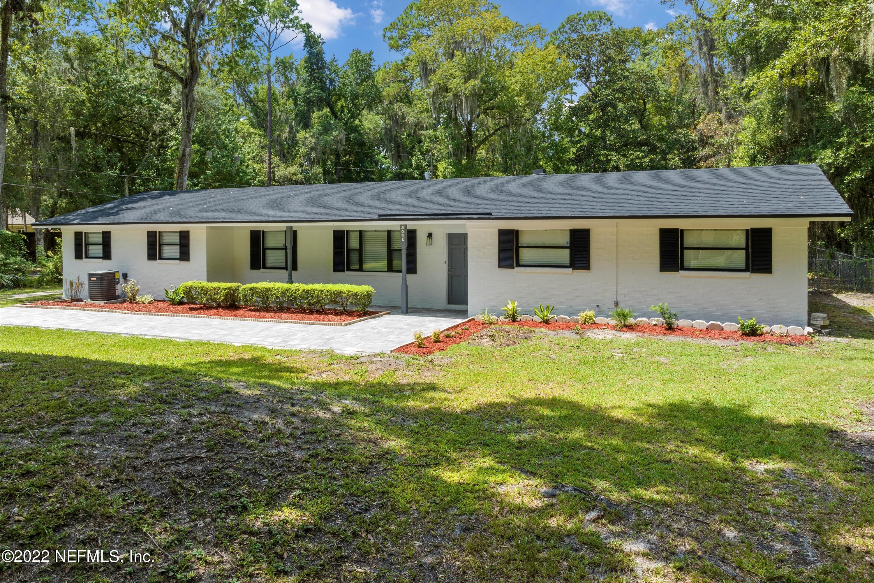 5092 Harvey Grant Road Fleming Island, FL 32003 - Photo 6 of 38 a front view of a house with a yard