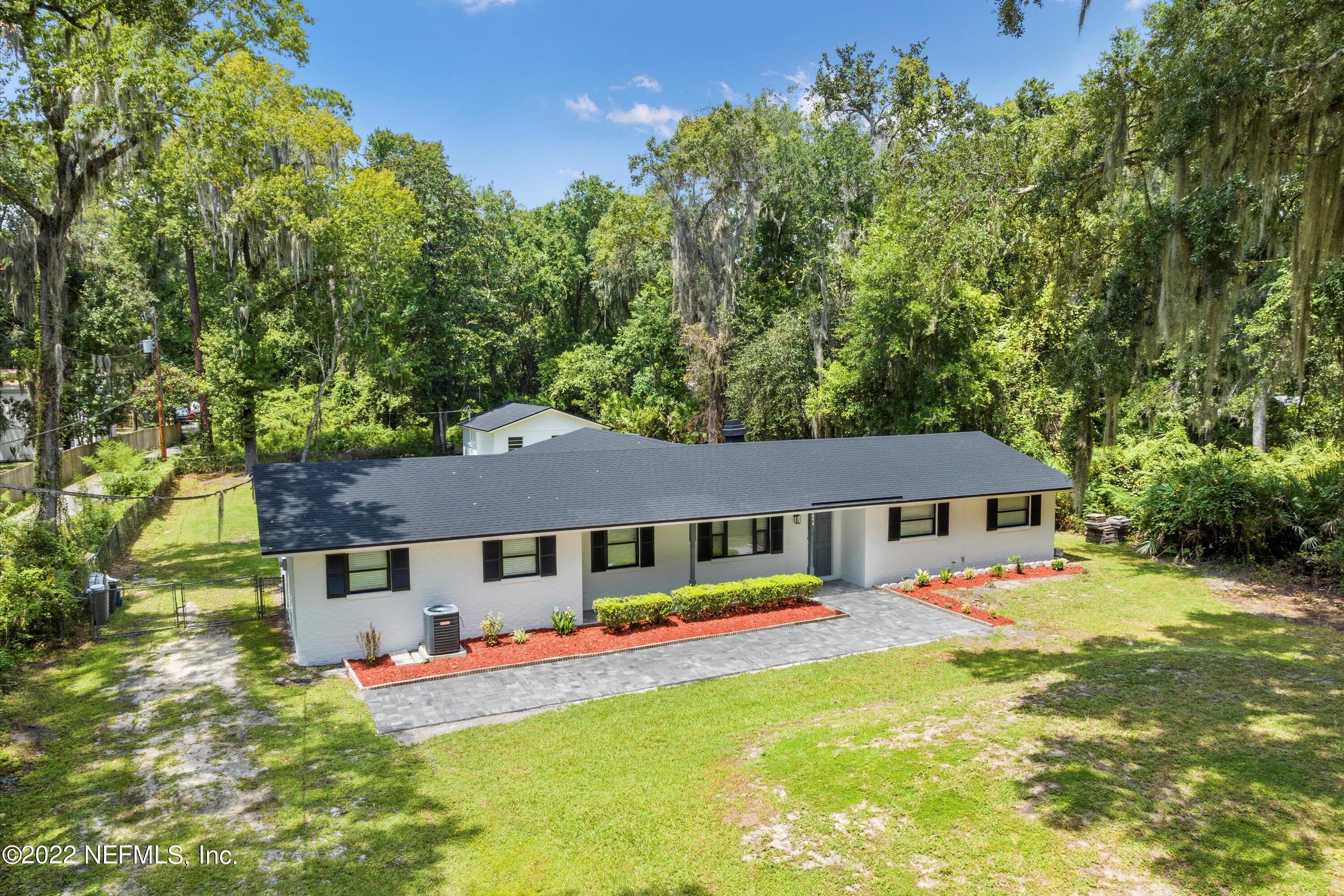 5092 Harvey Grant Road Fleming Island, FL 32003 - Photo 8 of 38 aerial view of a house with swimming pool and porch