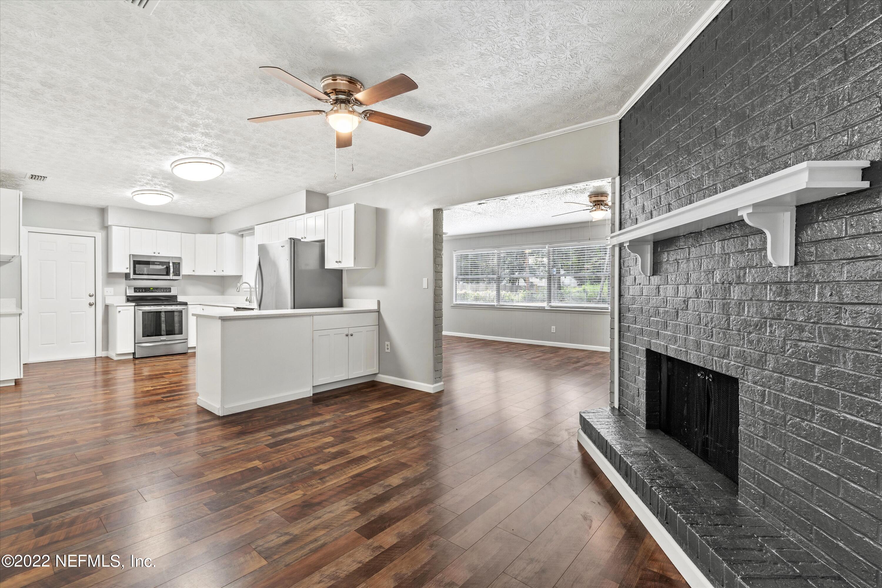 5092 Harvey Grant Road Fleming Island, FL 32003 - Photo 9 of 38 a view of a kitchen with a stove cabinets and wooden floor