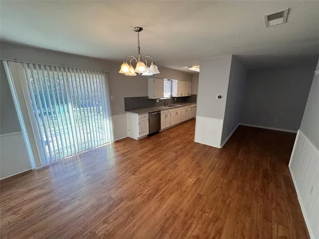 a view of a house with wooden floor and chandelier