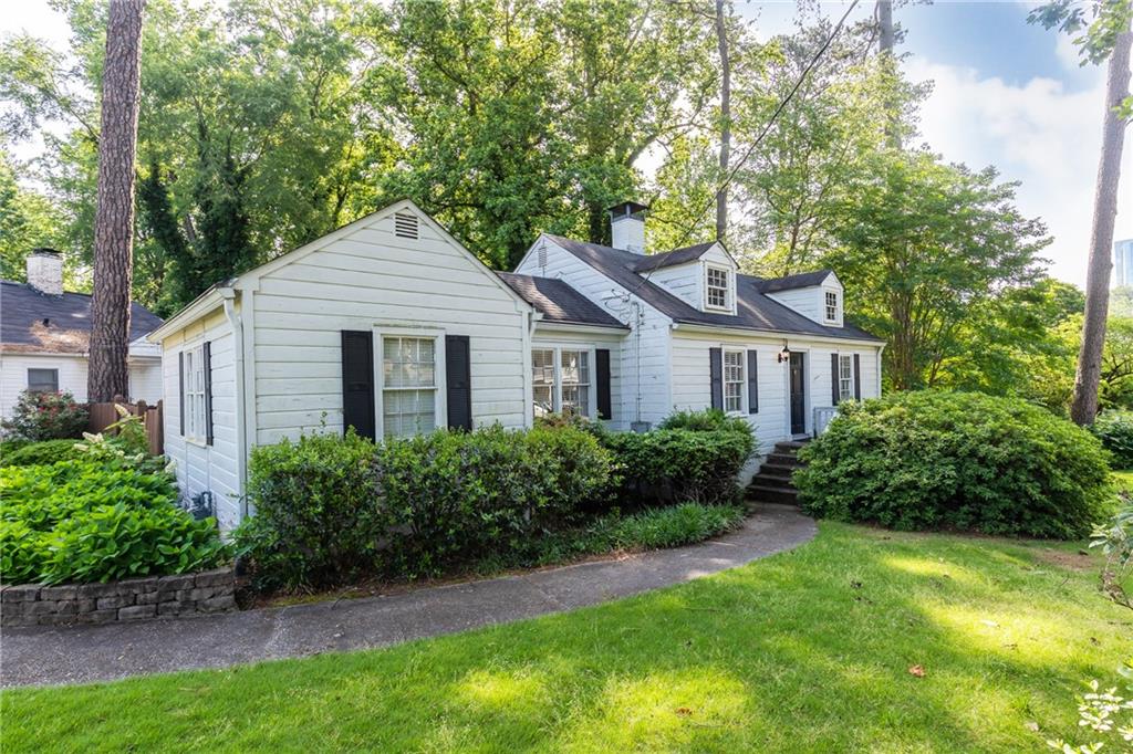 205 Old Ivy Road Northeast Atlanta, GA 30305 - Photo 1 of 1 a front view of a house with a yard and shrubs