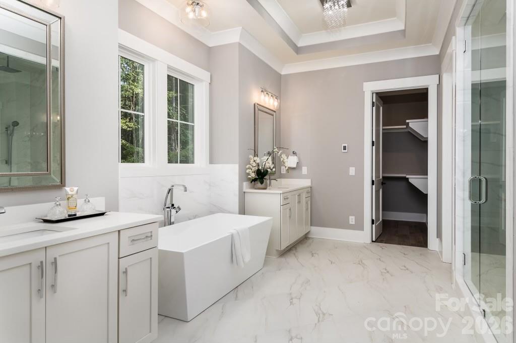 116 Silver Falls Road Troutman, NC 28166 - Photo 32 of 46 a bathroom with a double vanity sink a mirror and a
