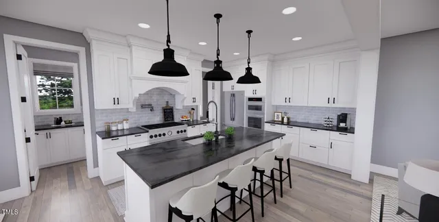 a kitchen with stainless steel appliances granite countertop a stove a refrigerator a oven with white cabinets and wooden floor