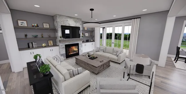 a living room with furniture a fireplace and a flat screen tv