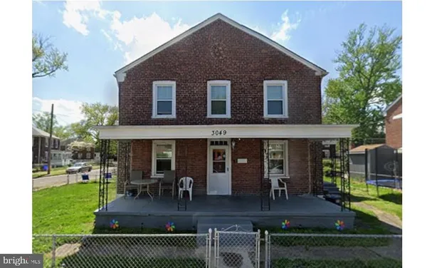 a view of house with a yard and patio