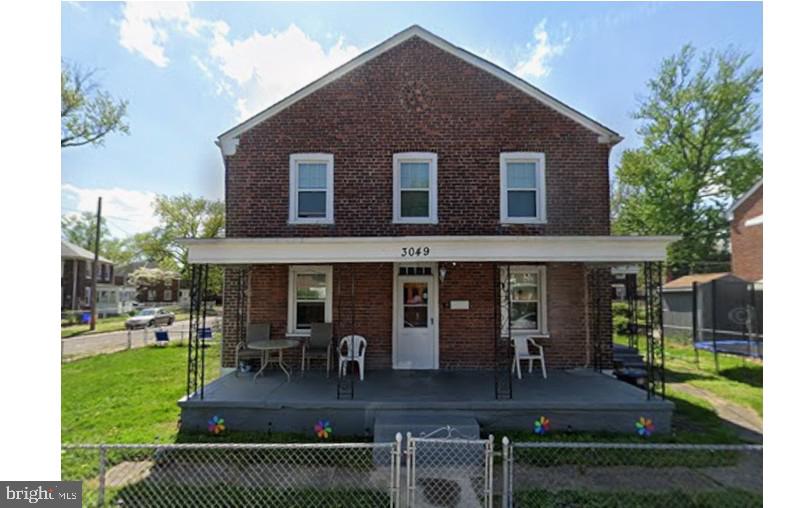 a view of house with a yard and patio