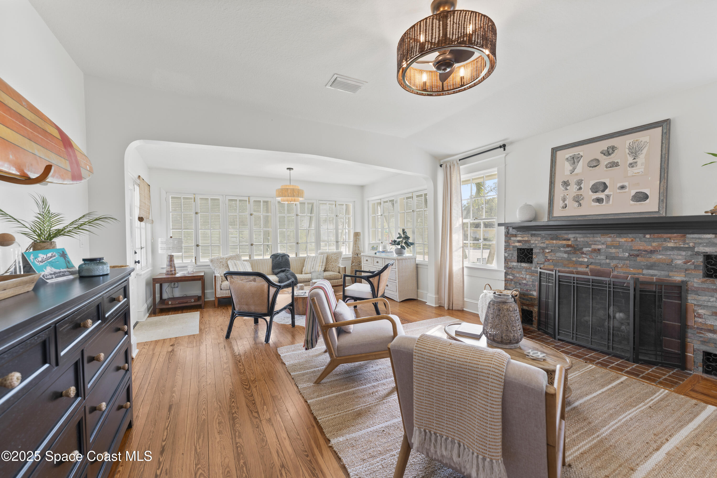 346 3rd Avenue Indialantic, FL 32903 - Photo 13 of 47 a living room with furniture a fireplace and a large window