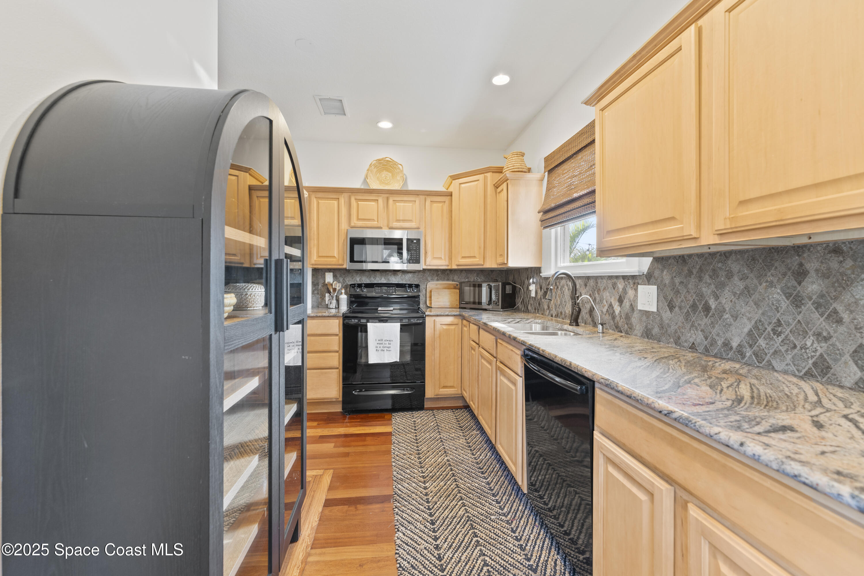 346 3rd Avenue Indialantic, FL 32903 - Photo 17 of 47 a kitchen with stainless steel appliances granite countertop a stove a sink and a refrigerator