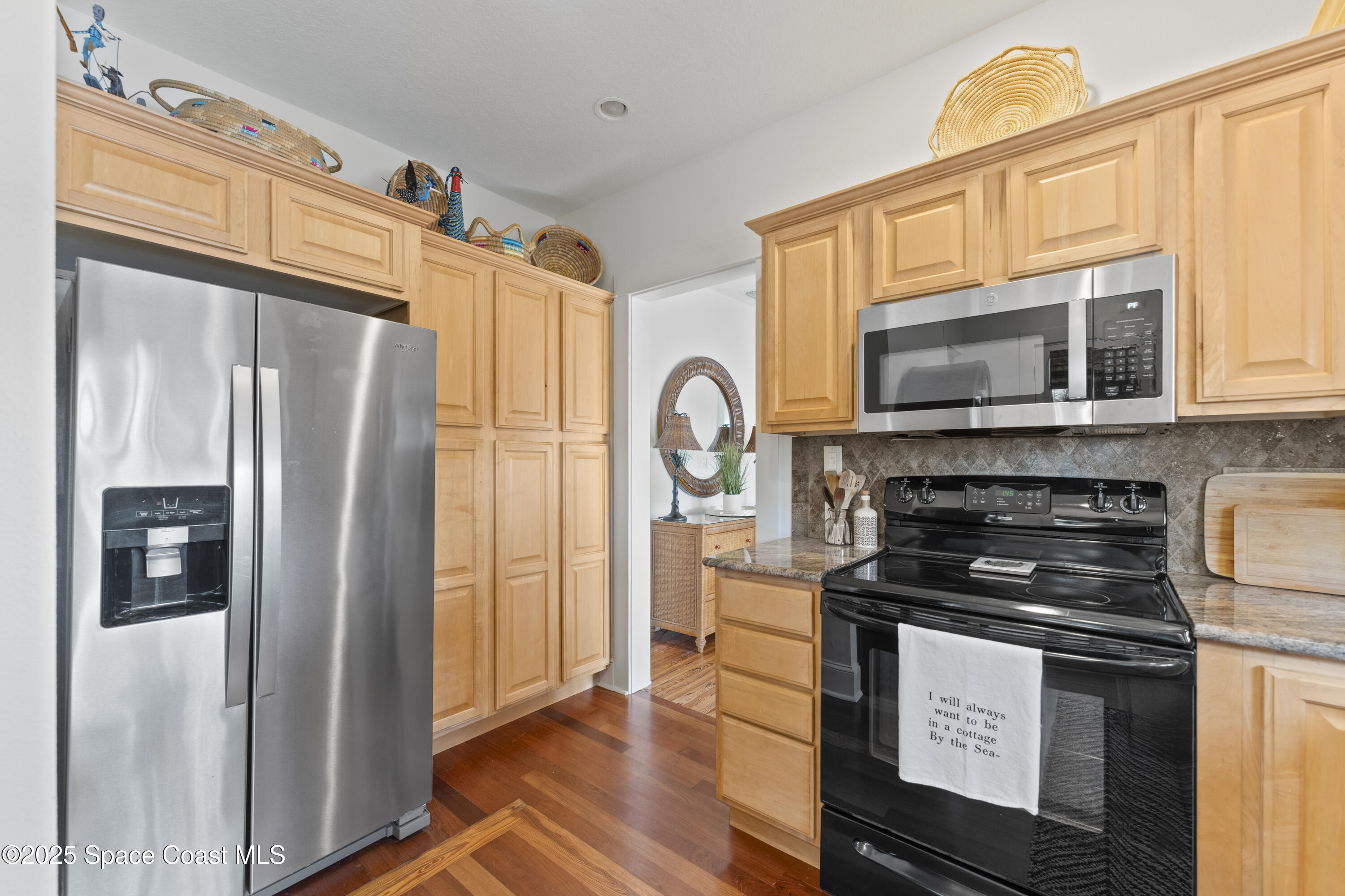 346 3rd Avenue Indialantic, FL 32903 - Photo 18 of 47 a kitchen with stainless steel appliances granite countertop a refrigerator stove and microwave