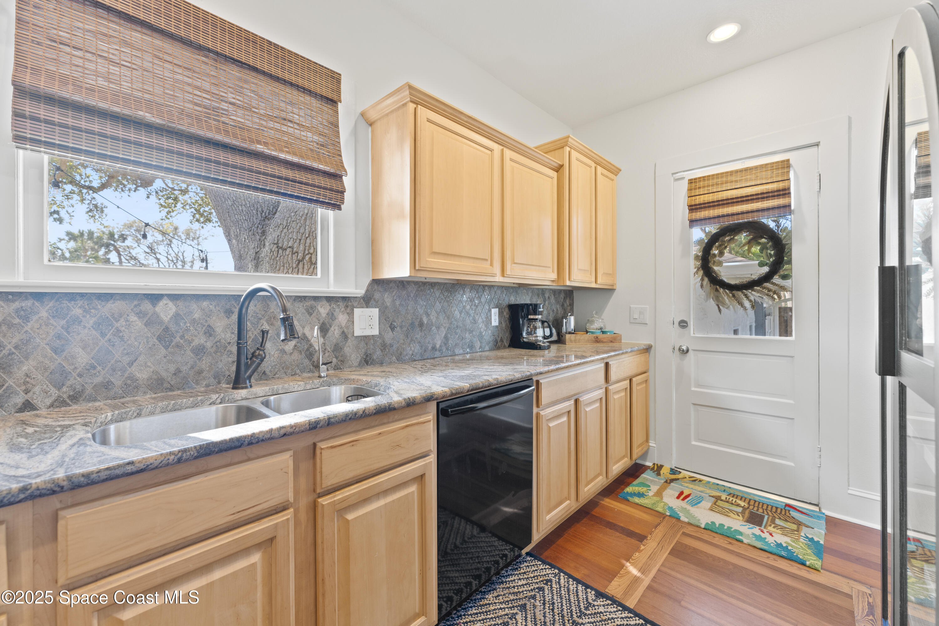 346 3rd Avenue Indialantic, FL 32903 - Photo 19 of 47 a kitchen with stainless steel appliances granite countertop a sink a stove and a window