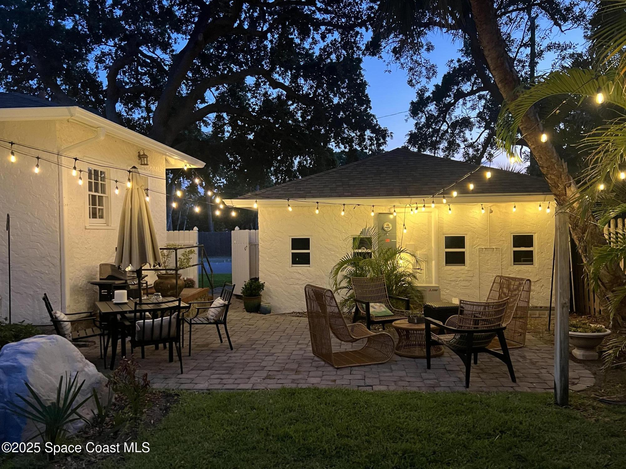 346 3rd Avenue Indialantic, FL 32903 - Photo 37 of 47 a view of a patio with table and chairs potted plants and a large tree