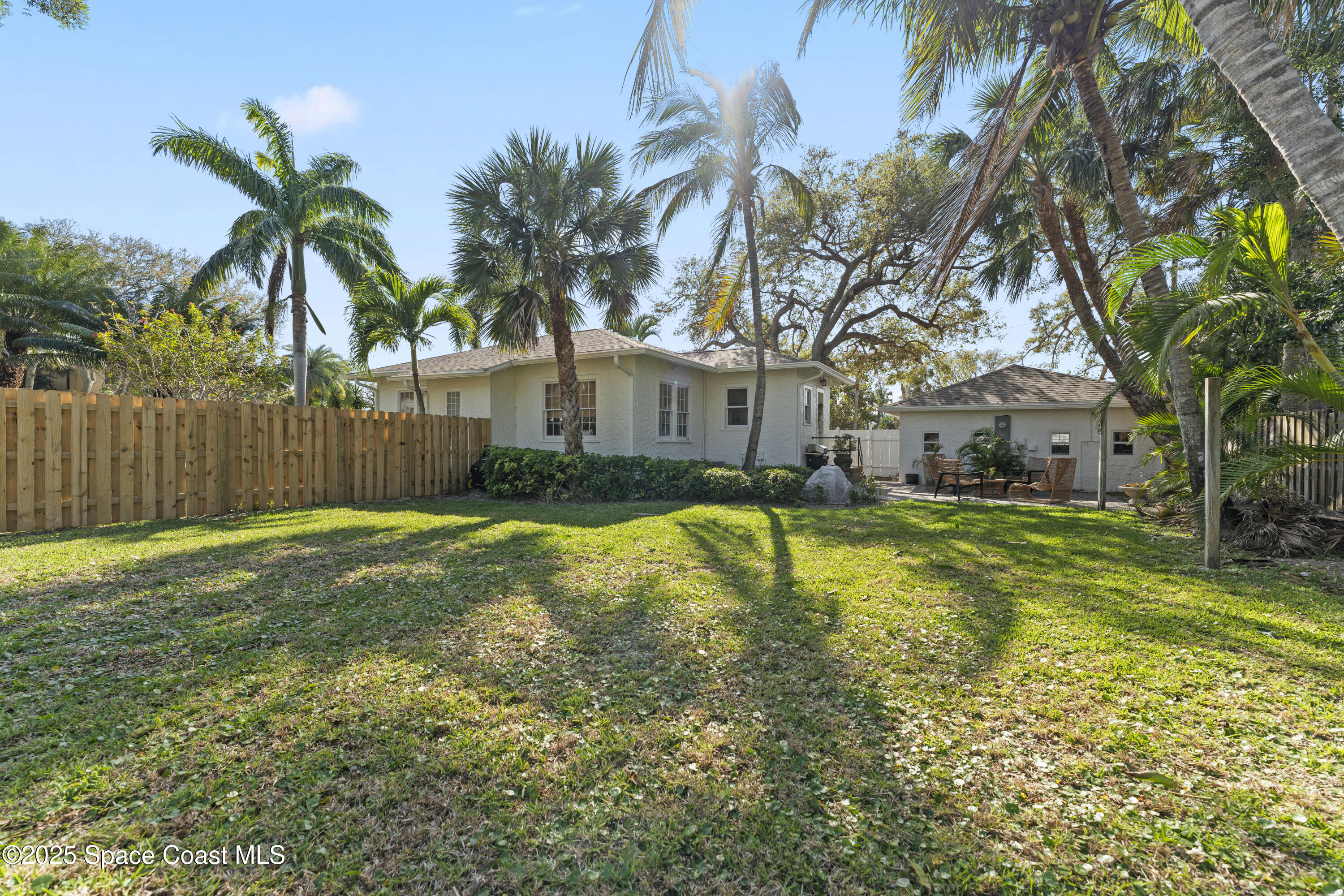346 3rd Avenue Indialantic, FL 32903 - Photo 7 of 47 a view of a yard with palm trees