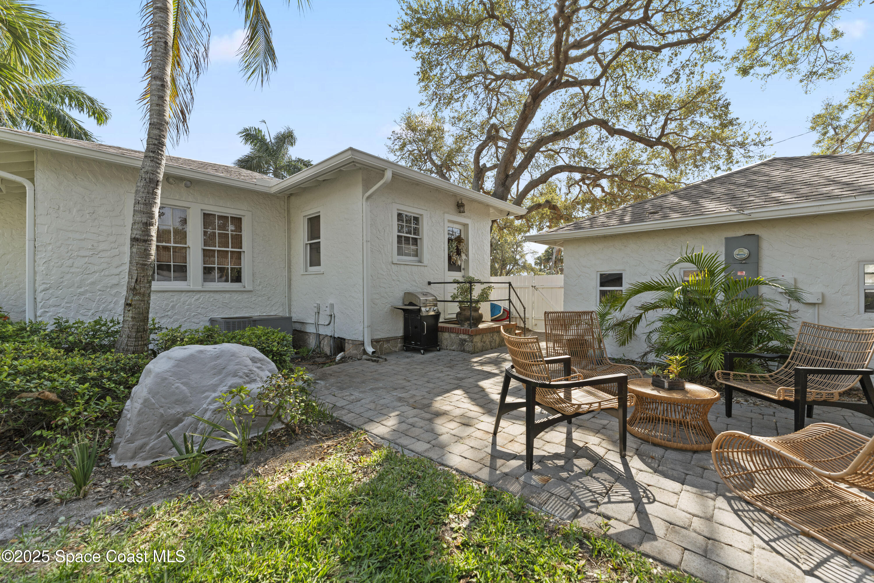 346 3rd Avenue Indialantic, FL 32903 - Photo 8 of 47 a backyard of a house with table and chairs