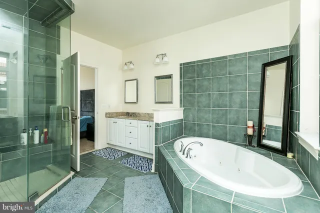 a living room with furniture a flat screen tv and a large window