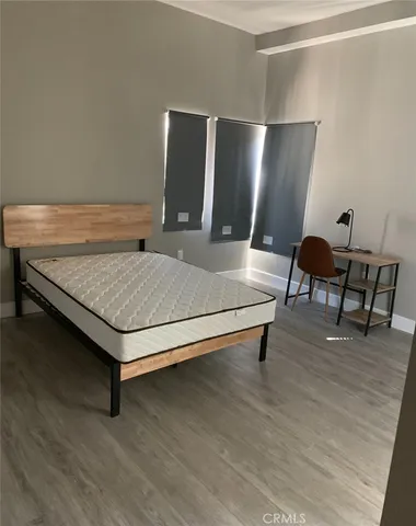 a bedroom with furniture and wooden floor
