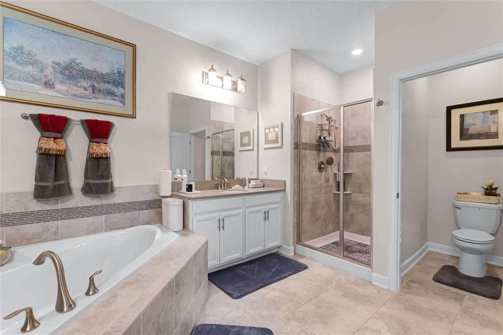 1089 Blackwolf Run Road Davenport, FL 33896 - Photo 22 of 82 a spacious bathroom with a shower a bathtub and a double vanity sink