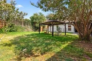 a backyard of a house with table and chairs