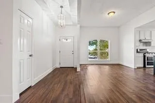 wooden floor in an empty room with a window