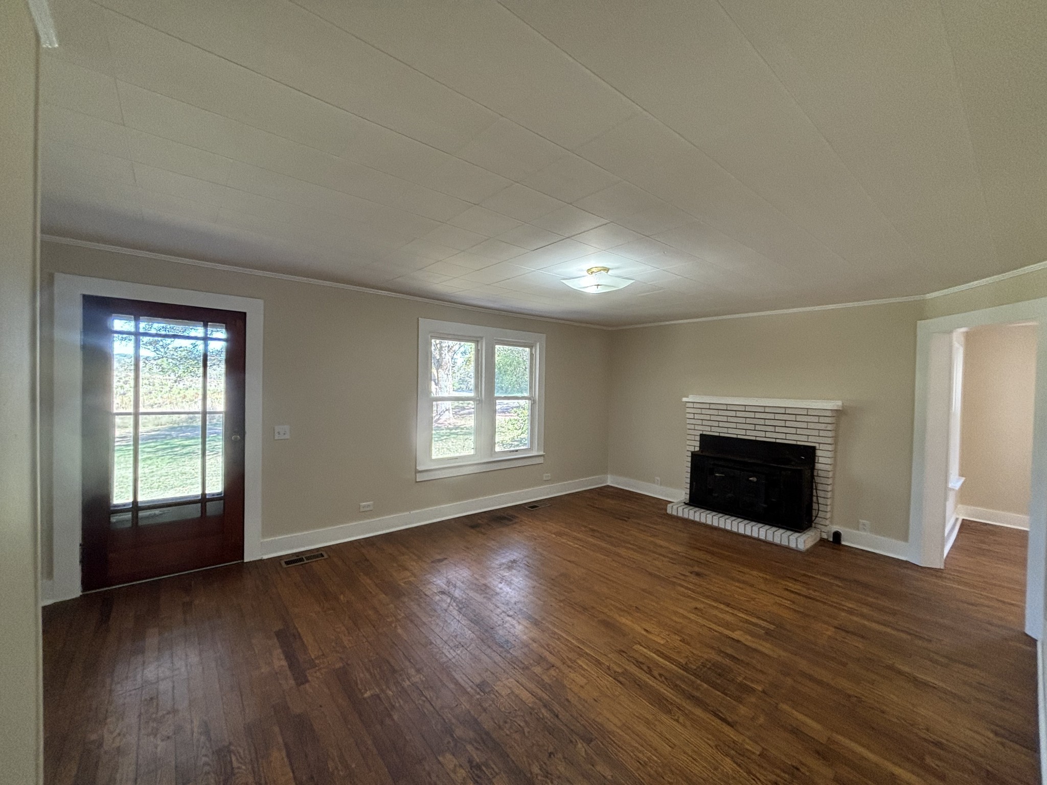 1893 Briar Patch Road Prospect, TN 38477 - Photo 17 of 43 an empty room with wooden floor fireplace and windows