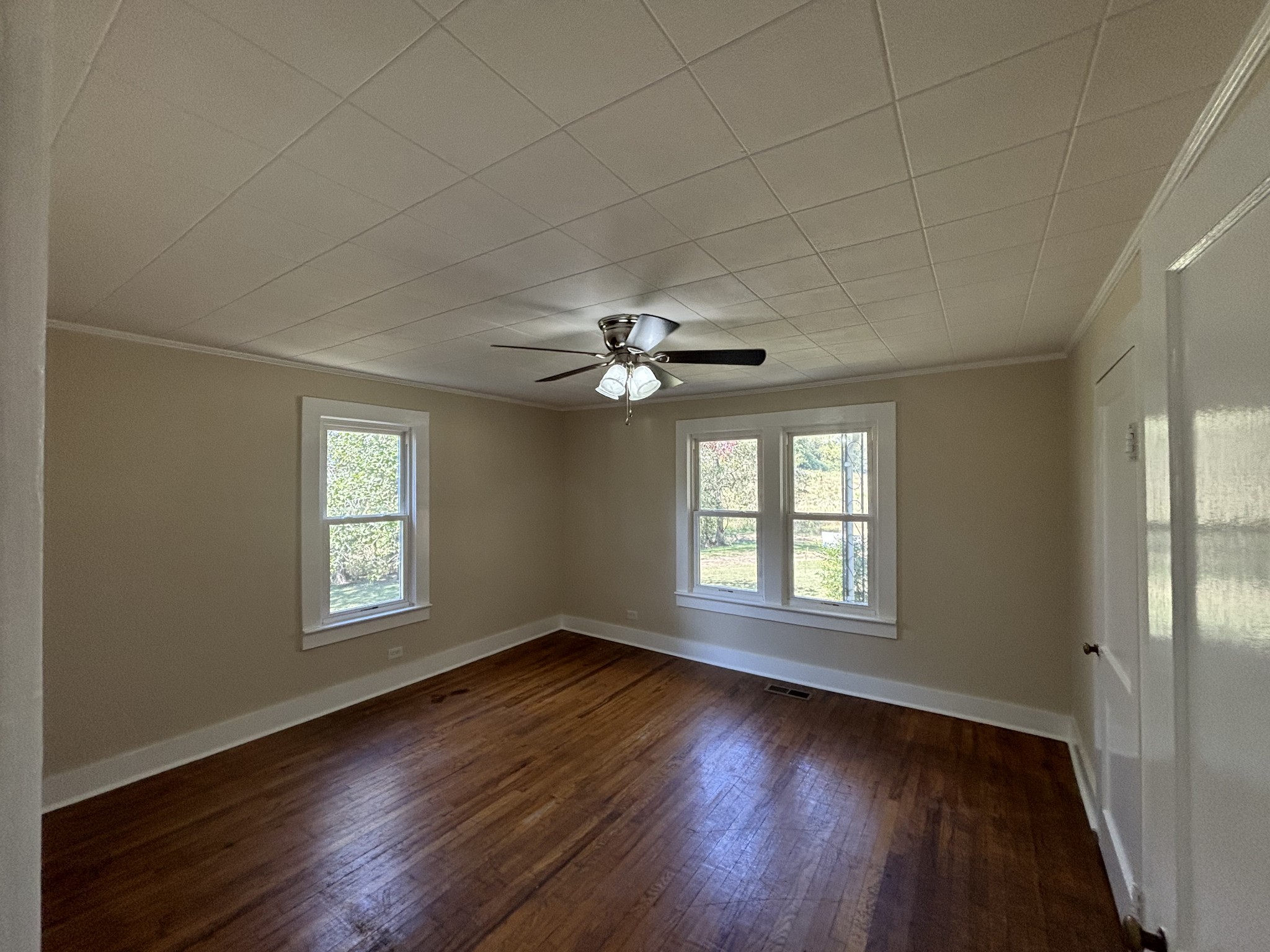1893 Briar Patch Road Prospect, TN 38477 - Photo 18 of 43 an empty room with wooden floor ceiling fan and windows