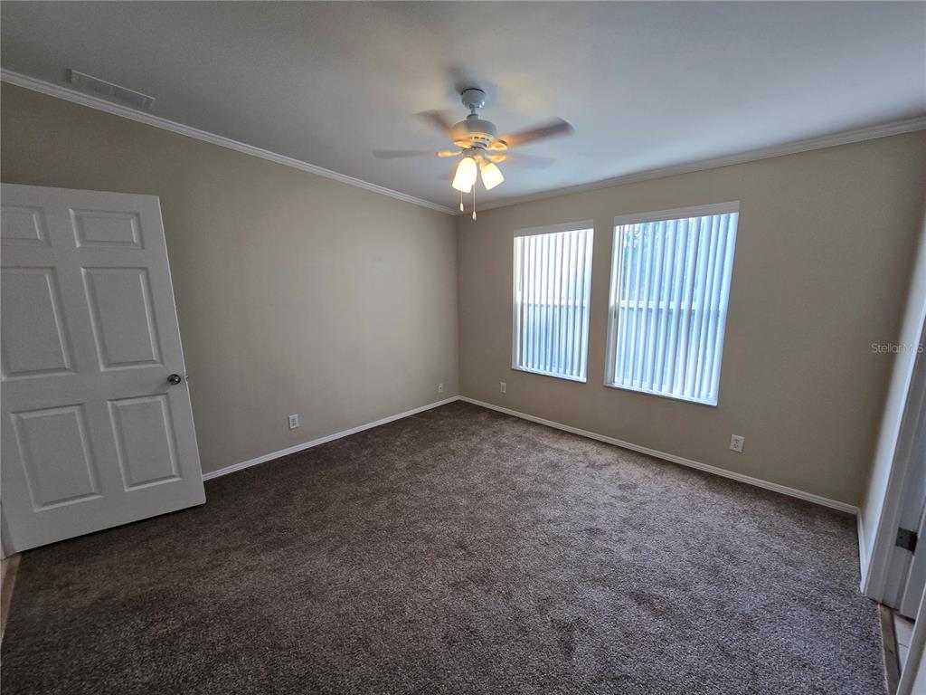 7644 Sailwinds Pass Port Richey, FL 34668 - Photo 14 of 22 an empty room with windows and ceiling fan