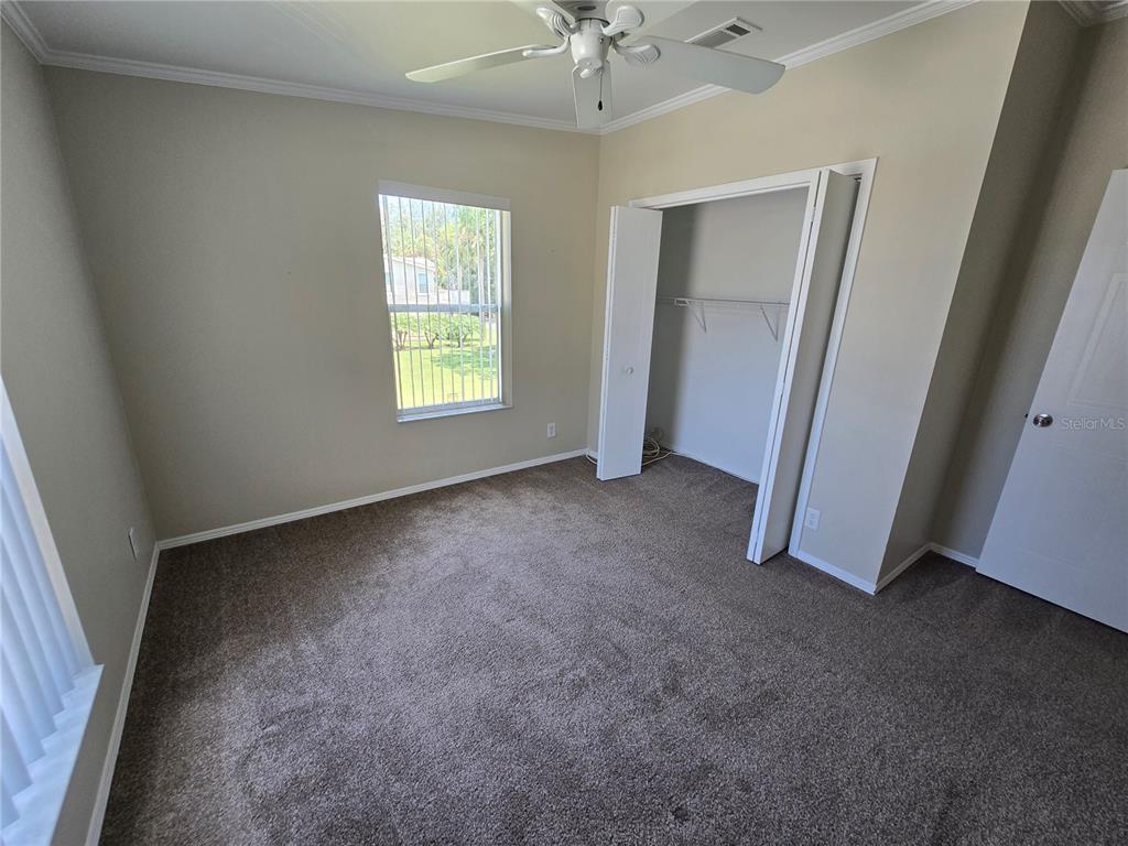 7644 Sailwinds Pass Port Richey, FL 34668 - Photo 16 of 22 a view of room with window and a ceiling fan