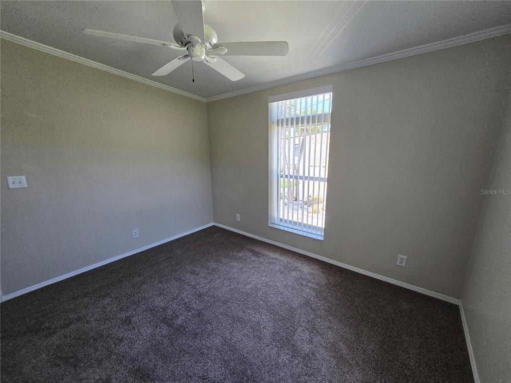 7644 Sailwinds Pass Port Richey, FL 34668 - Photo 17 of 22 an empty room with a window and a fan
