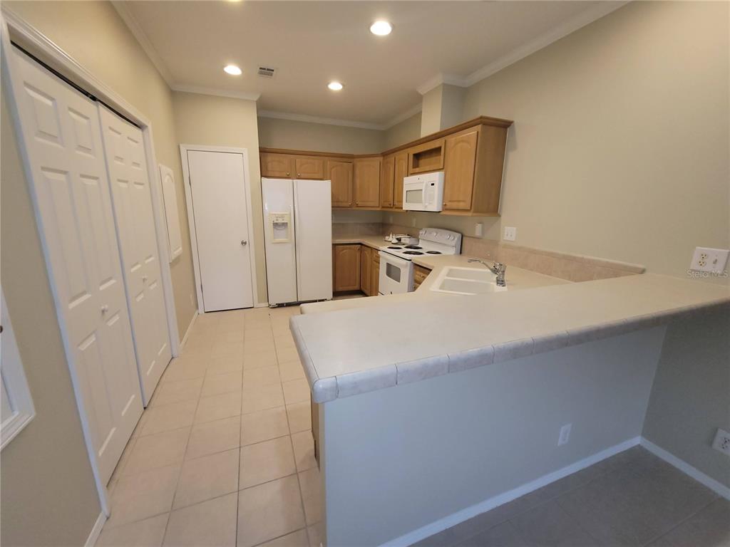 7644 Sailwinds Pass Port Richey, FL 34668 - Photo 8 of 22 a room with a bed a mirror and a sink