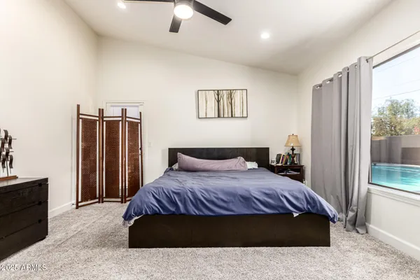a bedroom with a large bed and a dresser