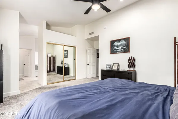 a bedroom with a bed and a chandelier