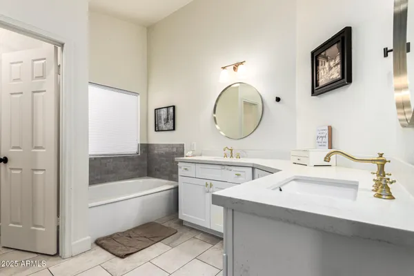 a bathroom with a toilet a sink a mirror and bathtub