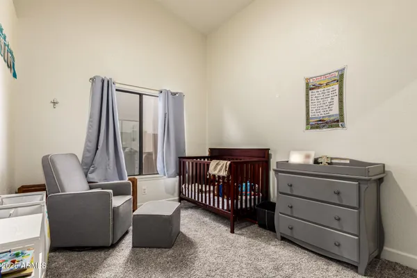 a bedroom with furniture and a window