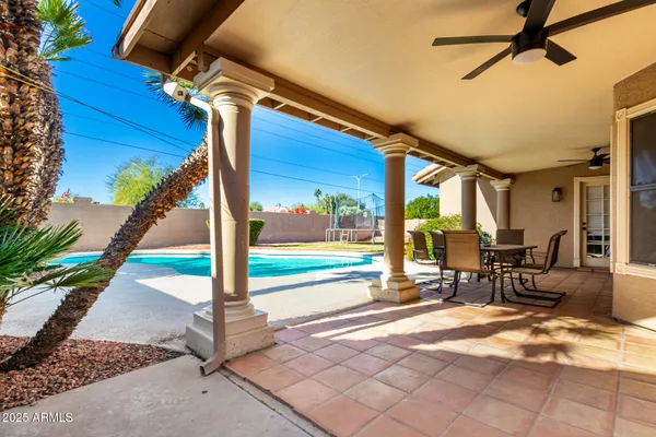a view of a patio with a table and chairs