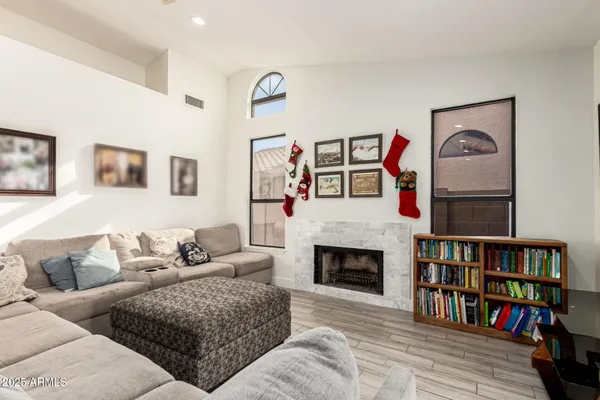 a living room with fireplace furniture and a book shelf