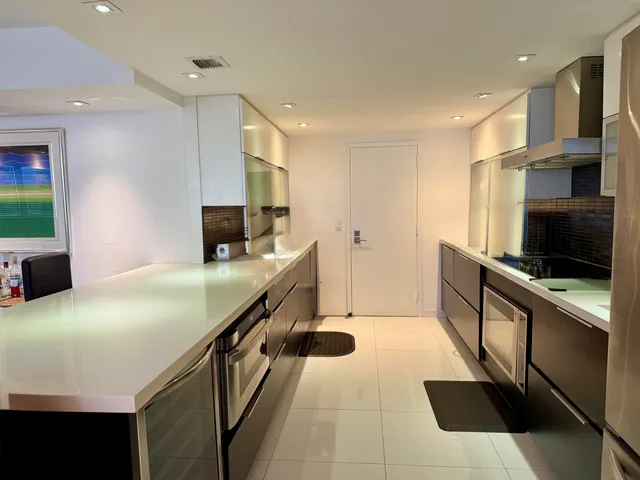 a kitchen with stainless steel appliances a stove microwave and cabinets