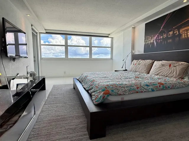 a bedroom with a large bed and a window