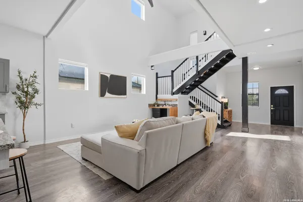 a living room with furniture and a wooden floor