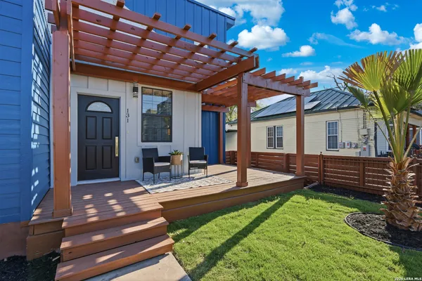 a view of a house with backyard and sitting area